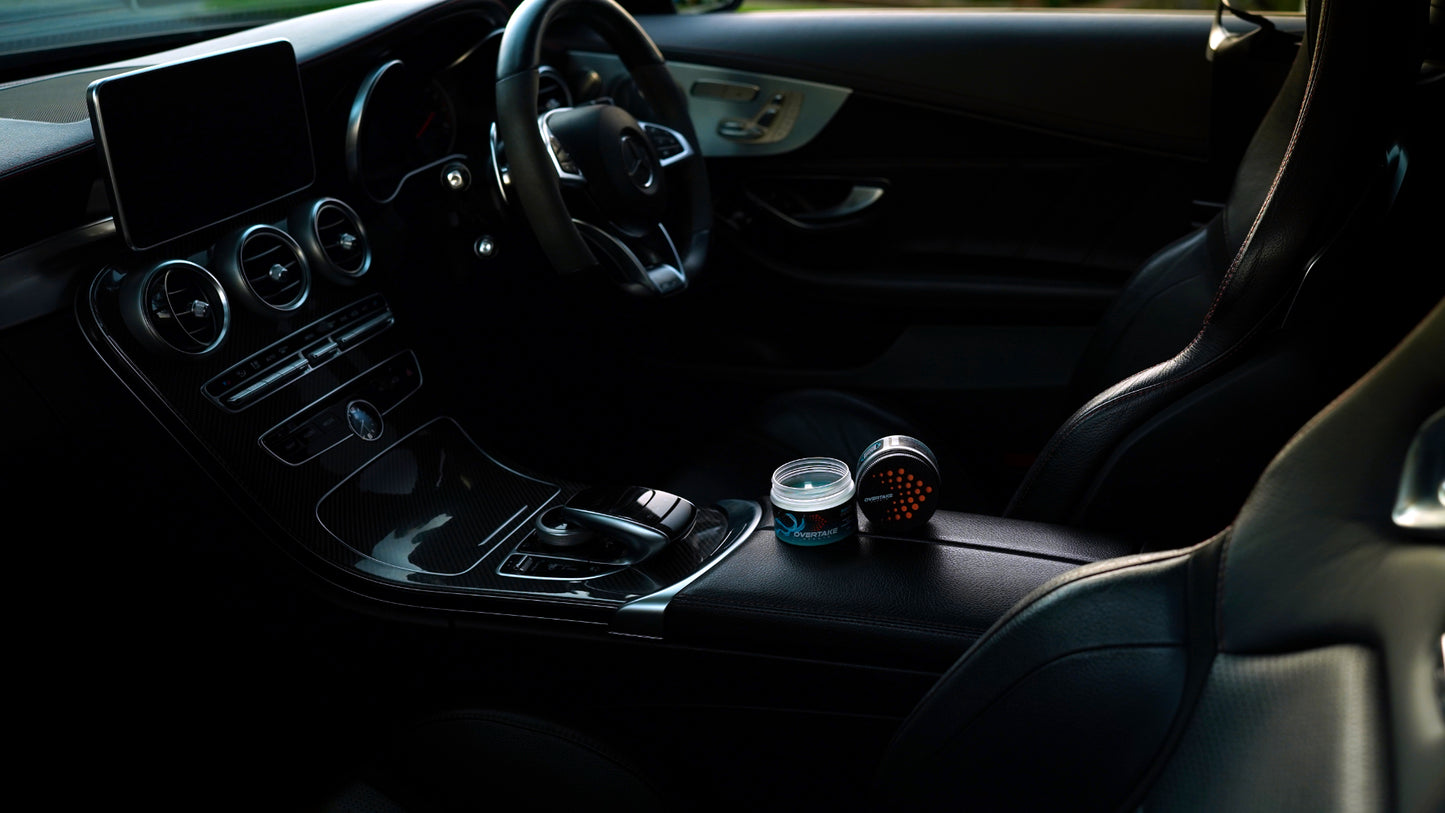 Aqua Fresh gel car air fresheners in Mercedes-Benz center console, full interior view with steering wheel and infotainment screen — Overtake Scents