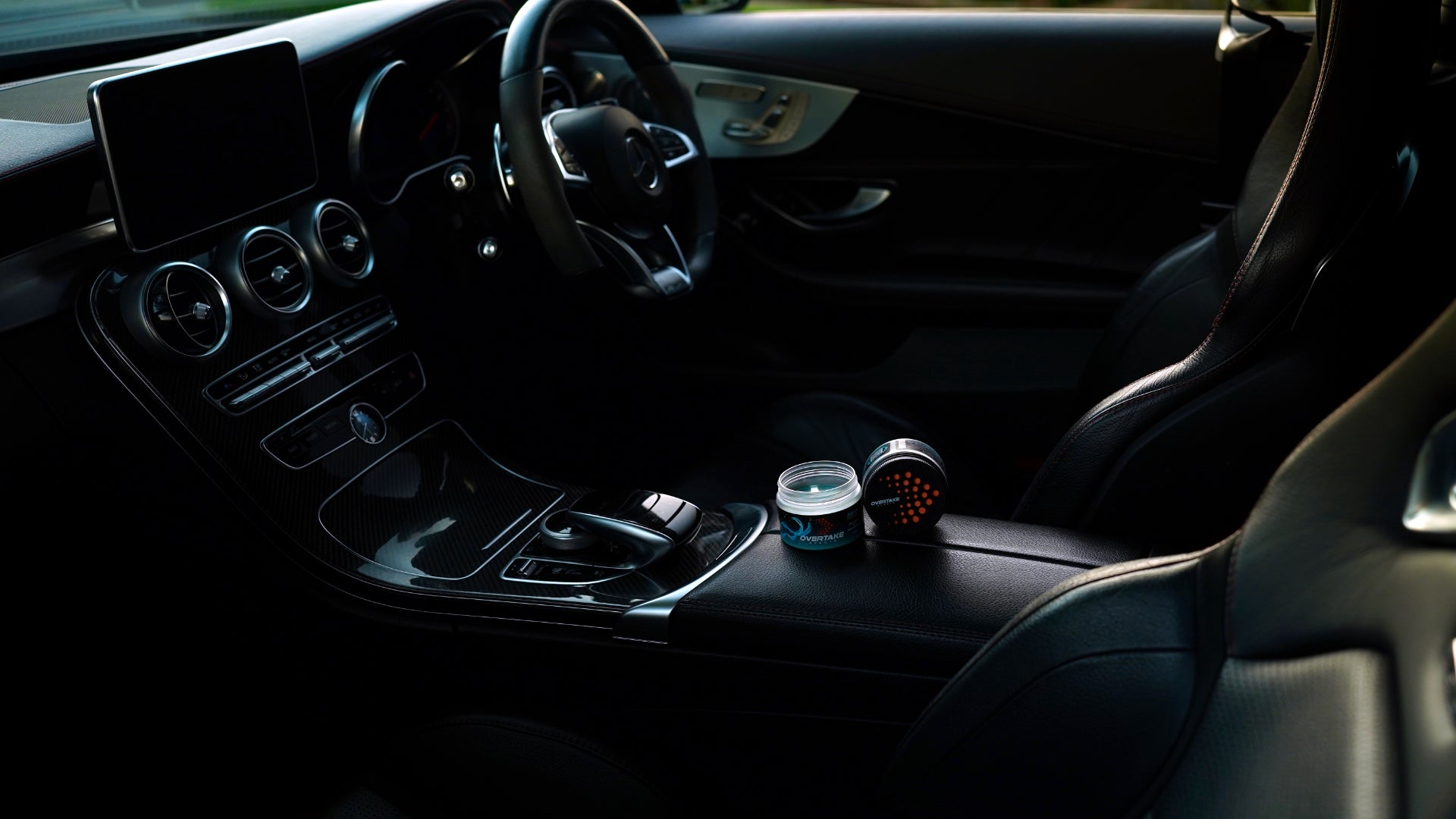 Aqua Fresh gel car air fresheners in Mercedes-Benz center console, full interior view with steering wheel and infotainment screen — Overtake Scents