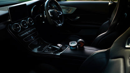 Aqua Fresh gel car air fresheners in Mercedes-Benz center console, full interior view with steering wheel and infotainment screen — Overtake Scents