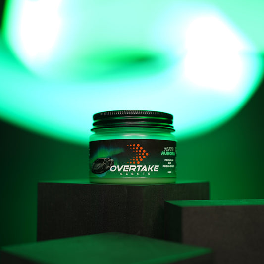Auto Aurora gel car air freshener on dark display podium with green aurora studio lighting — Overtake Scents