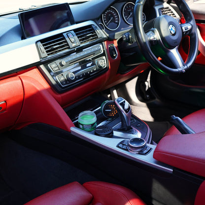 Auto Aurora gel car air freshener in BMW cup holder with red leather interior — Overtake Scents Melbourne