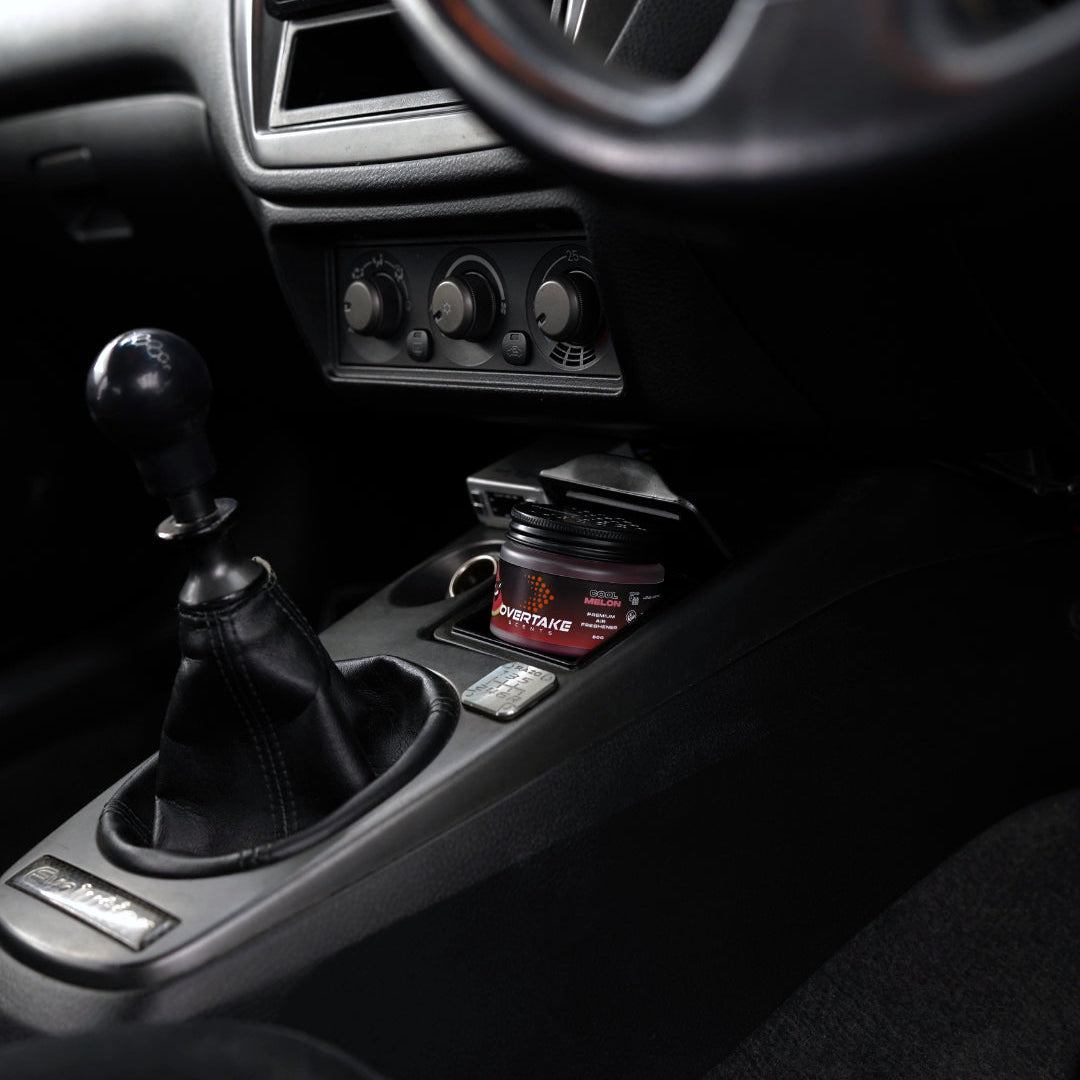 Cool Melon gel car air freshener in Mitsubishi Lancer Evolution center console, manual shifter and HVAC knobs visible — Overtake Scents