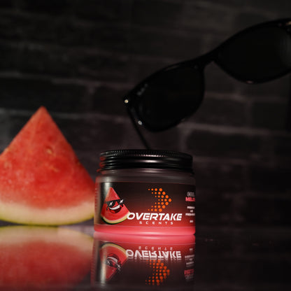 Cool Melon gel car air freshener flat lay with fresh watermelon slice and sunglasses on dark reflective surface — Overtake Scents