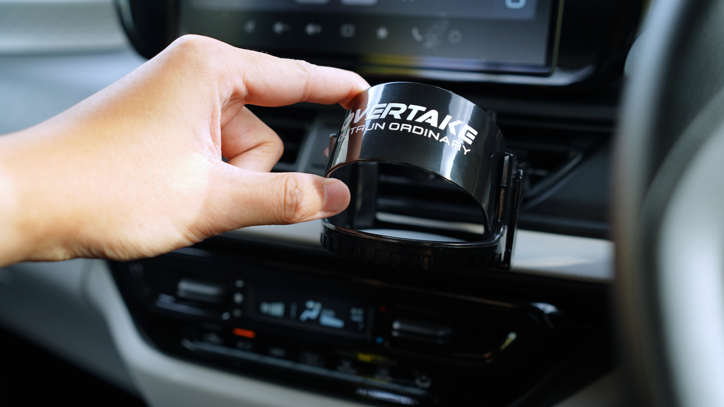 Overtake vent mount holding gel car air freshener in car vent, front sun visor half open — Overtake Scents
