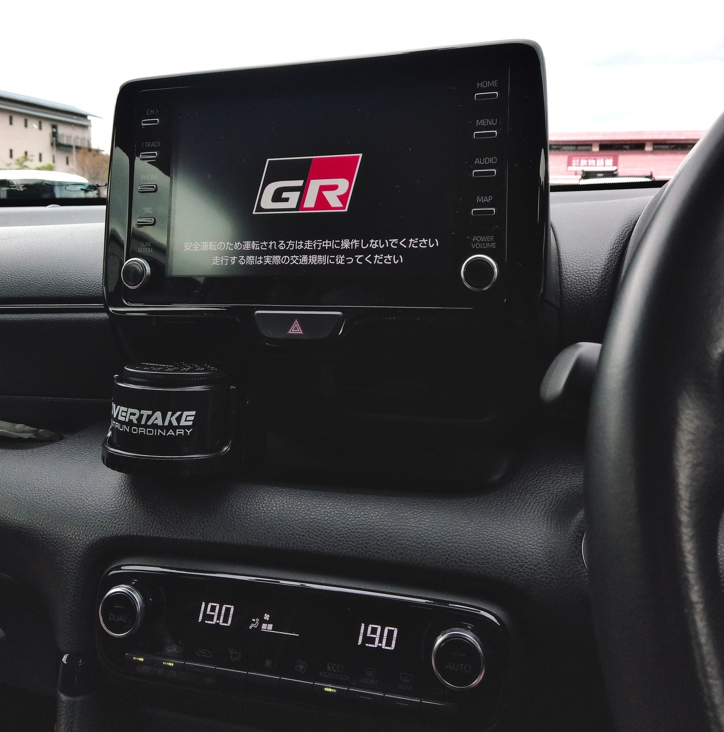 Overtake vent mount and gel air freshener in Toyota GR center console, GR Gazoo Racing infotainment screen visible — Overtake Scents