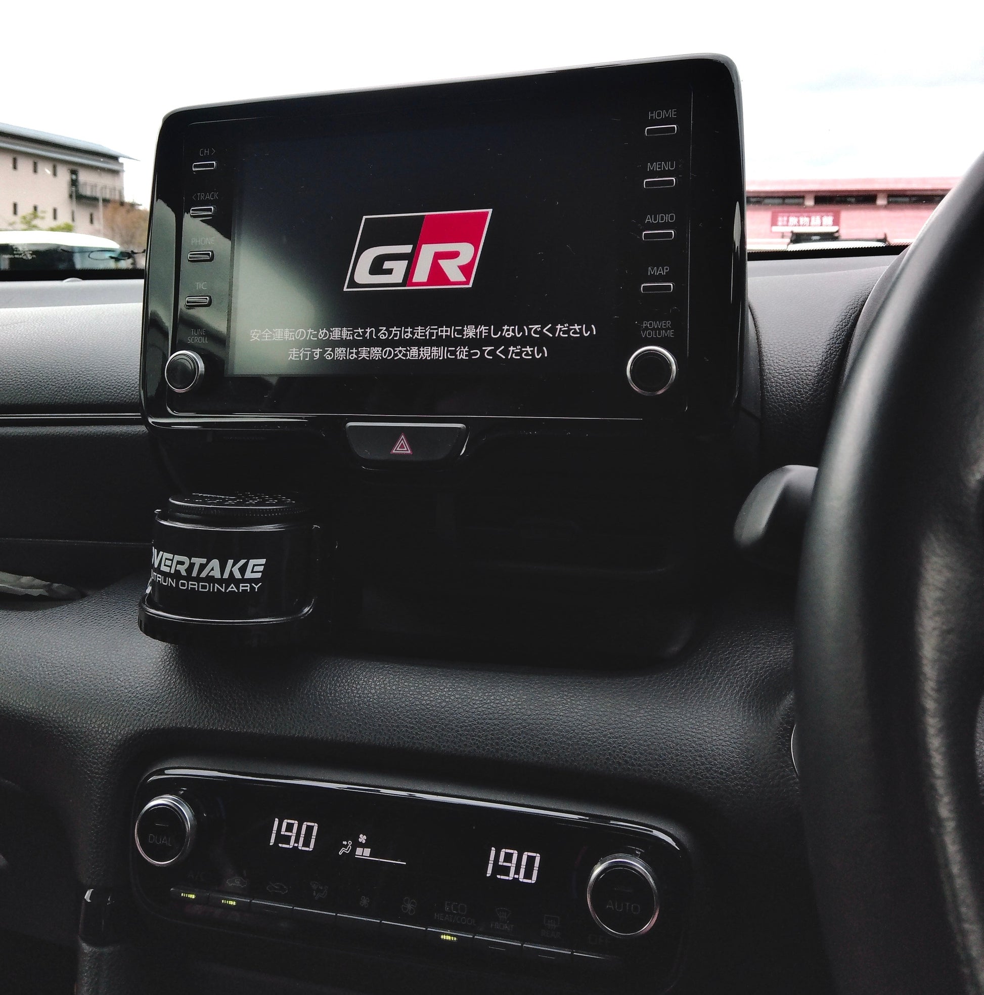 Overtake vent mount and gel air freshener in Toyota GR center console, GR Gazoo Racing infotainment screen visible — Overtake Scents