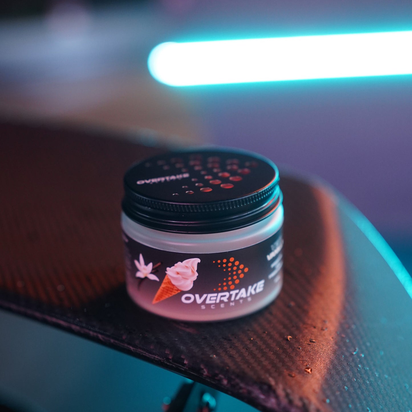 Very Vanilla gel car air freshener on car surface with teal neon ambient lighting — Overtake Scents